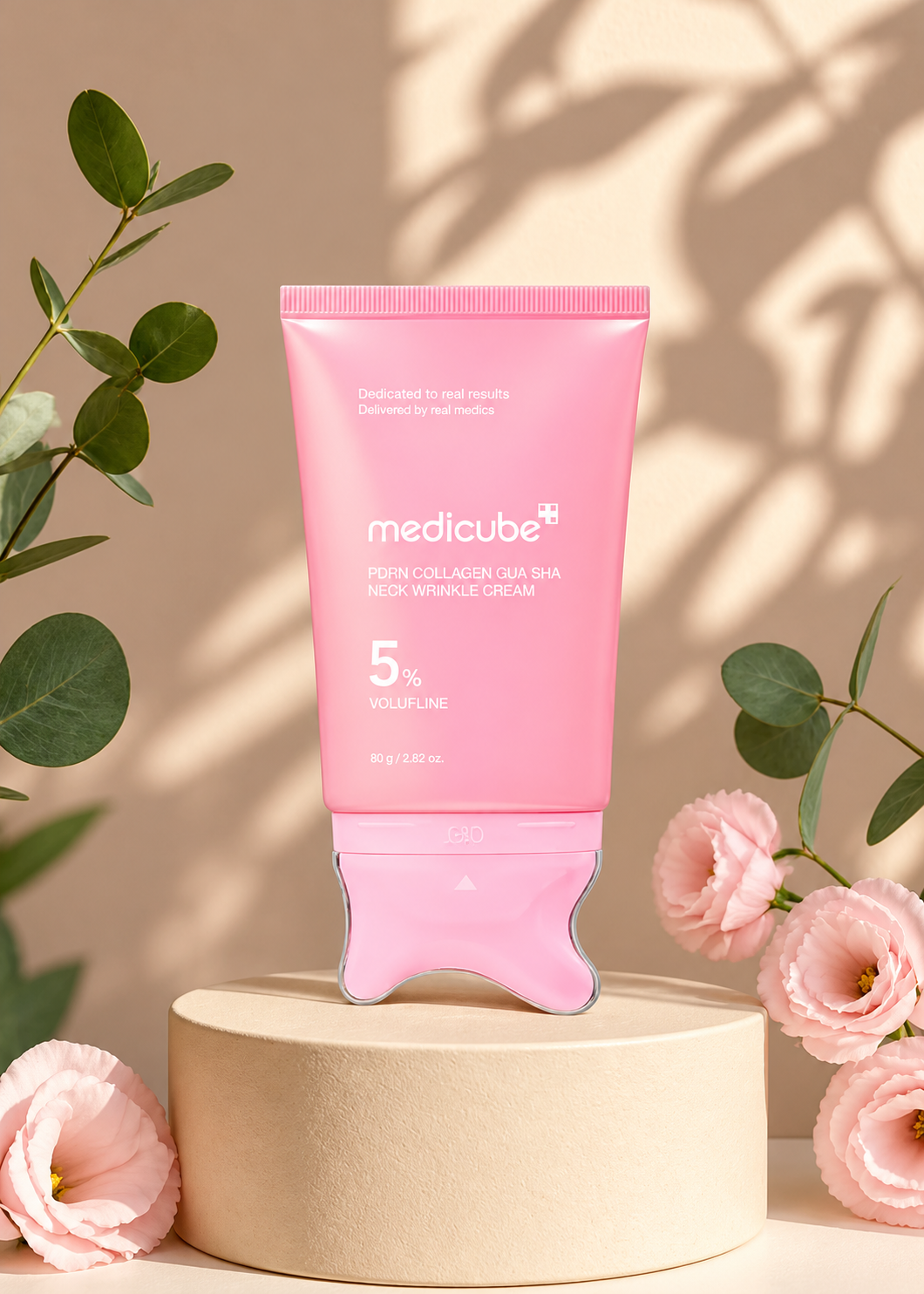 Medicube PDRN Collagen Gua Sha Neck Wrinkle Cream on a stone pedestal with pink flowers